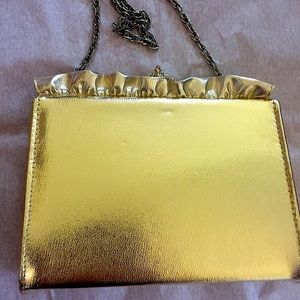 Gold evening clutch.  Chain strap. Clasp closure.